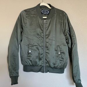 Dark green jacket with zippers on the sleeves